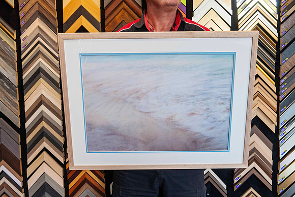 A single framed artwork from a Collection of artworks professionally framed with matching natural timber frames and individually colour-matched accent mounts for an exhibition at Sunset Framing & Gall