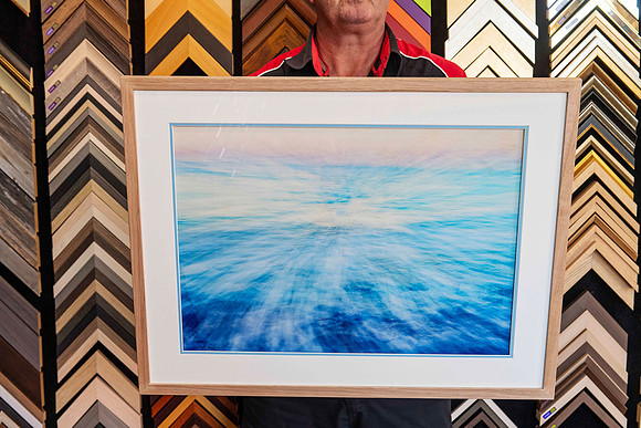 A single framed artwork from a Collection of artworks professionally framed with matching natural timber frames and individually colour-matched accent mounts for an exhibition at Sunset Framing & Gall