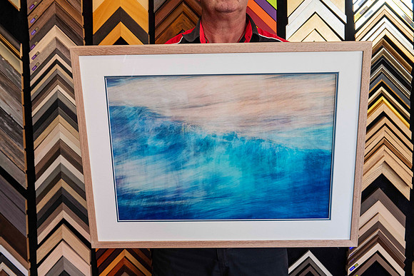 A single framed artwork from a Collection of artworks professionally framed with matching natural timber frames and individually colour-matched accent mounts for an exhibition at Sunset Framing & Gall