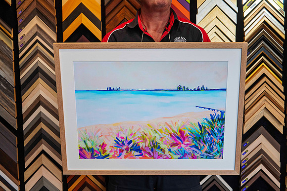 Contemporary coastal landscape artwork custom framed with a natural timber frame, conservation white mount and blue accent mount by Sunset Framing & Gallery Port Macquarie.