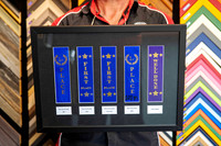 Boys athletics and cross-country award ribbons including first place ribbons, individually mounted and professionally custom framed in Port Macquarie.