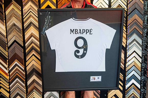 Signed Kylian Mbappé soccer jersey custom framed with black timber frame and conservation mounting by Sunset Framing & Gallery Port Macquarie.