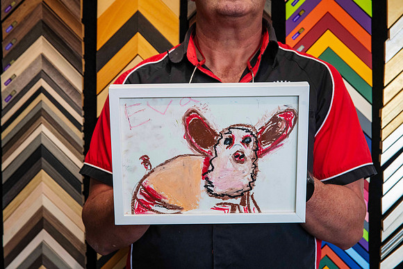 Kids artwork featuring a colourful hand-drawn animal, professionally custom framed in a simple white frame in Port Macquarie.