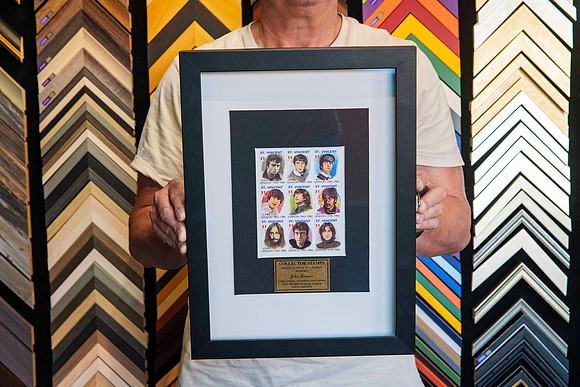 John Lennon collectable commemorative stamp sheet professionally custom framed with black and white matboards and a black frame in Port Macquarie.