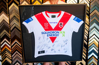 Team-signed St George Illawarra Dragons red and white NRL jersey professionally mounted and custom framed as sporting memorabilia in Port Macquarie.