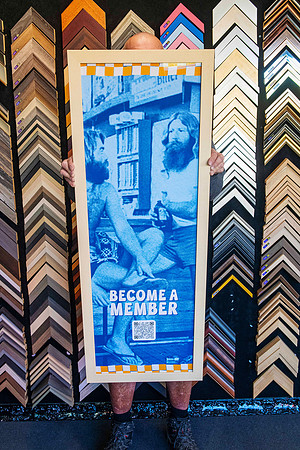 Large vertical promotional banner professionally custom framed in a timber frame, demonstrating oversize and large format picture framing in Port Macquarie.