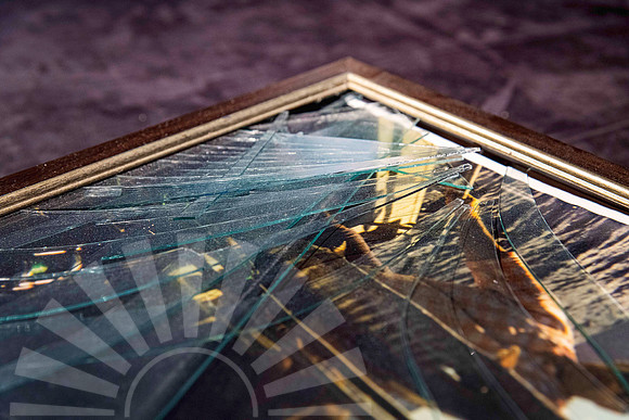 Picture frame with shattered glass after an ageing hanging cord broke and caused the frame to fall from the wall, requiring professional frame repair in Port Macquarie.