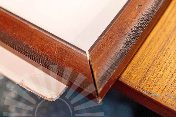 Timber picture frame with separated corner joint before being cleaned and rejoined during professional frame repair in Port Macquarie.