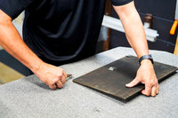 Old backing being removed from a vintage framed print as part of a complete professional reframe using updated framing materials in Port Macquarie.