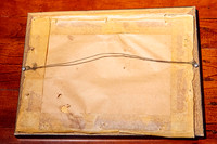 Back of an old picture frame showing aged timber backing, old tape and wire hanging system before professional frame repair and upgrade in Port Macquarie.
