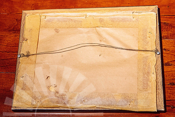 Back of an old picture frame showing aged timber backing, old tape and wire hanging system before professional frame repair and upgrade in Port Macquarie.