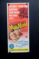 Original 1957 Man Afraid Australian daybill movie poster featuring vivid red and yellow illustrated artwork with George Nader and Phyllis Thaxter.
