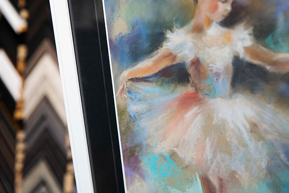 Close-up detail of a softly coloured ballerina artwork framed with a wide black mat and slim white custom picture frame in Port Macquarie.