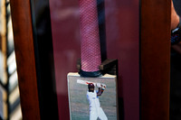 Close-up of custom framed signed Sir Viv Richards cricket bat showing the grip, secure mounting and cricket photograph against a burgundy background in a timber shadow box frame.