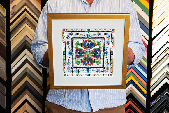 Colourful detailed needlework and embroidery custom framed with a wide neutral surround and warm gold frame by Sunset Framing & Gallery in Port Macquarie.
