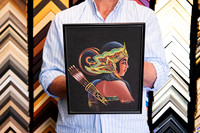 Colourful traditional figurative artwork on a black background custom framed in a slim black picture frame, showing a simple framing approach that keeps attention on the artwork.