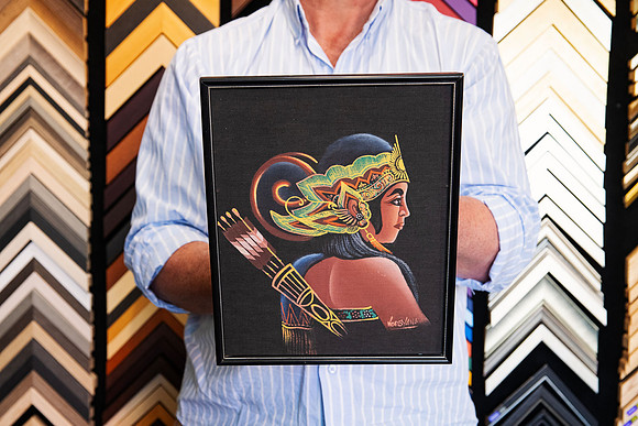 Colourful traditional figurative artwork on a black background custom framed in a slim black picture frame, showing a simple framing approach that keeps attention on the artwork.