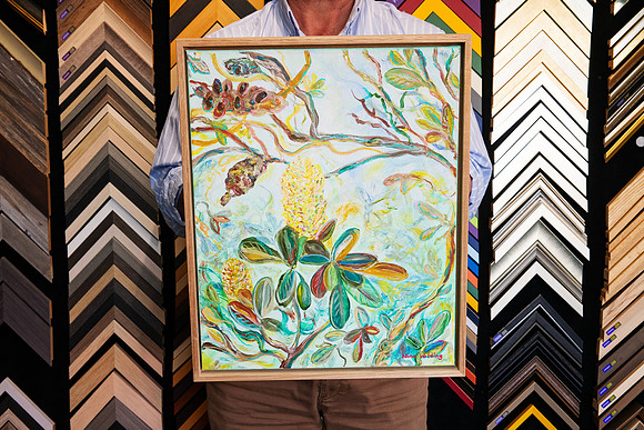 Original Australian native botanical painting by Nina Wilding featuring banksia flowers and foliage, custom framed in a slim natural timber canvas float frame in Port Macquarie.