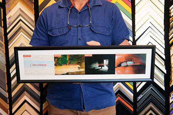 Four collected travel prints displayed together in a wide black custom frame with a clean white surround.