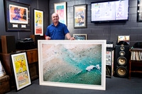 Oversized coastal photograph in a contemporary white custom frame held by framer Scott at Sunset Framing & Gallery, Port Macquarie.
