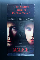 Malice Australian Daybill with shadowed close-ups of Alec Baldwin and Nicole Kidman, blue eyes, a red review quote above and the red film title below.