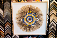 Woven fibre and feather artwork professionally custom framed in natural timber by a Port Macquarie picture framer.