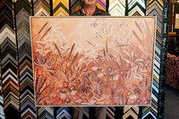 Large botanical artwork in earthy tones custom framed with a slim natural timber picture frame.