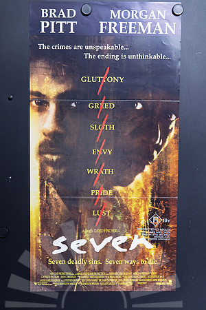 Seven Australian Daybill featuring shadowed portraits of Brad Pitt and Morgan Freeman, with the seven deadly sins listed in yellow and crossed by red slashes above a white title.