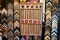 Red black and ochre Aboriginal artwork with dot patterns custom framed in timber.