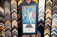 Classic Star Wars movie poster custom framed with dark mat and black frame.
