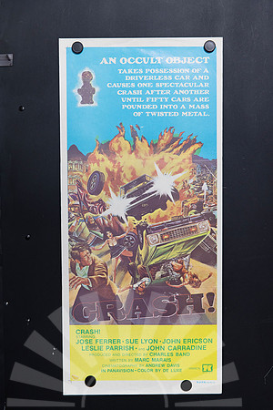 Crash! Australian Daybill depicting cars flying through an orange explosion, wrecked vehicles and fleeing people, with an occult idol against a bright blue background.