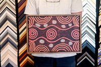 Orange black and white Aboriginal dot painting custom framed with a narrow timber frame.