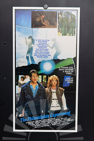 The Philadelphia Experiment Australian Daybill featuring Michael Paré and Nancy Allen beneath a montage of a fenced compound, protective suits and a glowing orb, with an angled blue title.