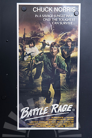 Battle Rage Australian Daybill showing an illustrated Chuck Norris carrying a gun through a jungle battle, with armed men and a yellow explosion behind him.
