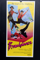 Breakdance Australian Daybill with three dancers posing against a yellow background, blue geometric panels and paint splashes, above a bold pink and black title.