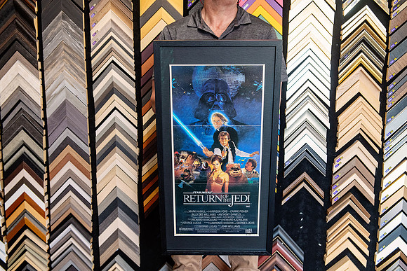 Star Wars Return of the Jedi movie poster custom framed in a dark frame and mat.